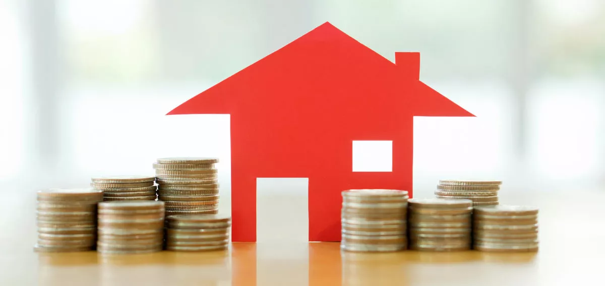 House and small stacks of coins.