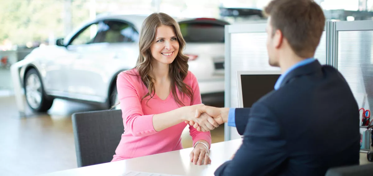 Woman finalizing car purchase