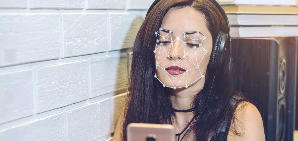 Woman using facial recognition on phone