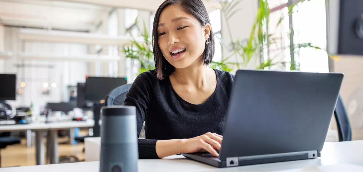 Woman using a voice assistant device