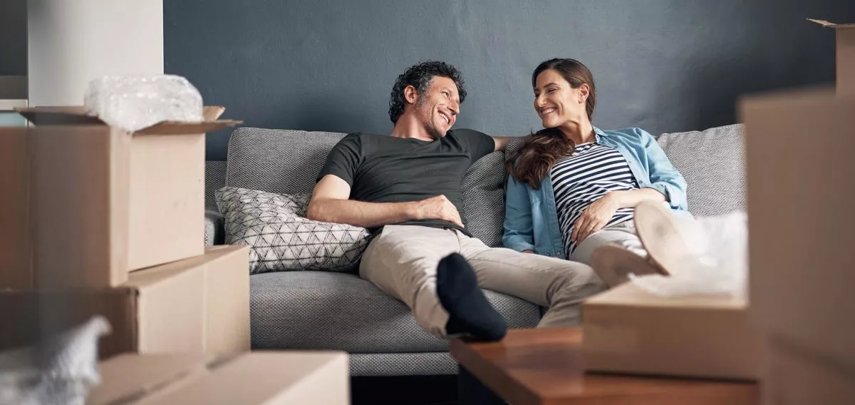 Husband and wife relaxing on couch