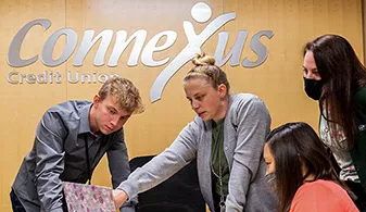 Connexus employees looking at computer