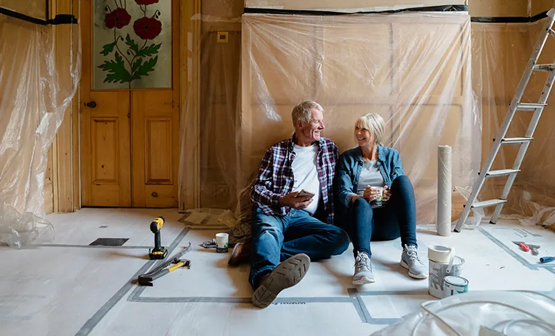 couple taking a break from remodeling home