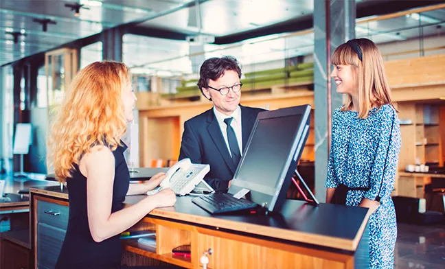 people standing at a reception desk