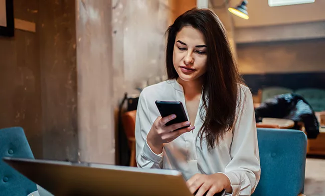 woman at home looking at smartphone