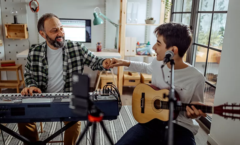 father and son playing music together