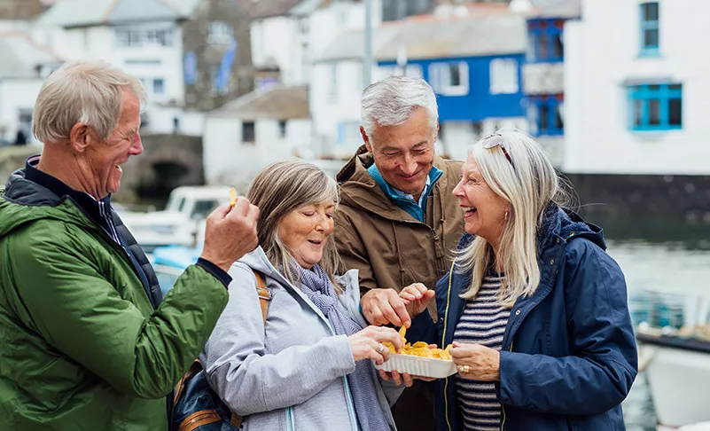 couples eating street food on the dock