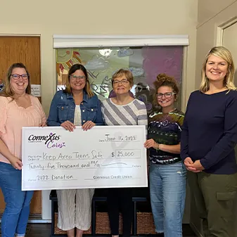 image of connexus cares volunteers presenting big check