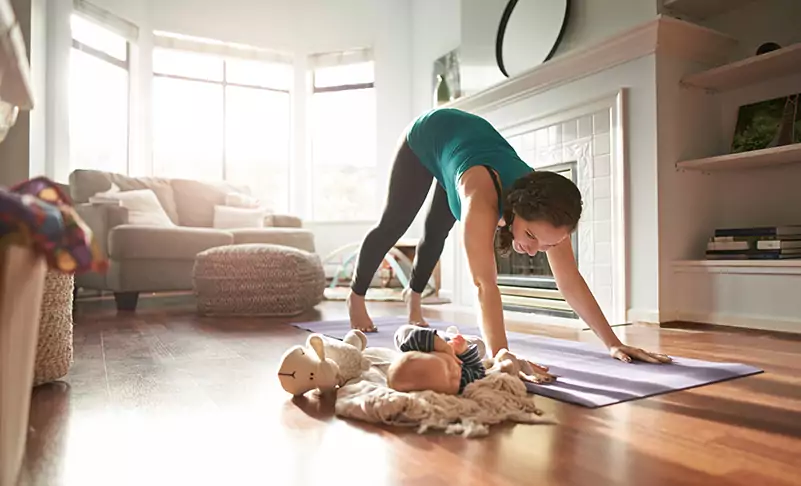 woman doing yoga in her home