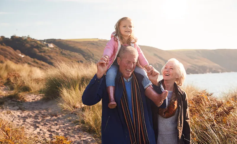 family walking by the sea