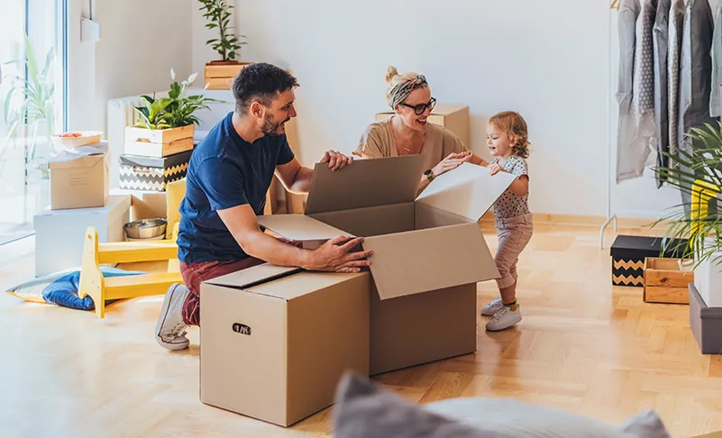 family unpacking moving boxes