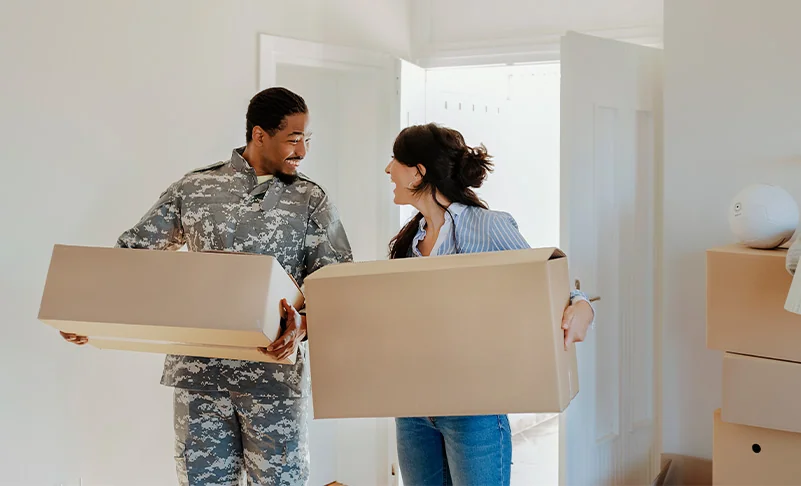 couple unpacking boxes in new home