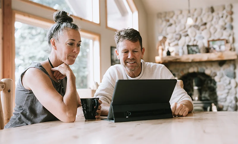 couple looking at laptop at home