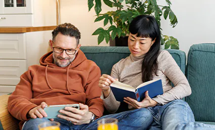 man and woman reading on the couch