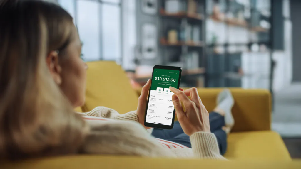 woman on couch looking at phone