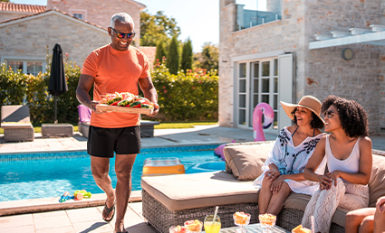 group of people eating by a pool