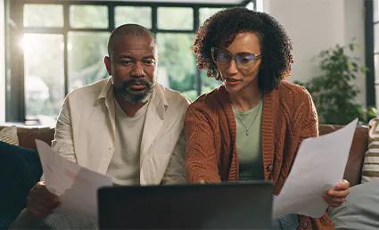 couple sitting together and reviewing finances