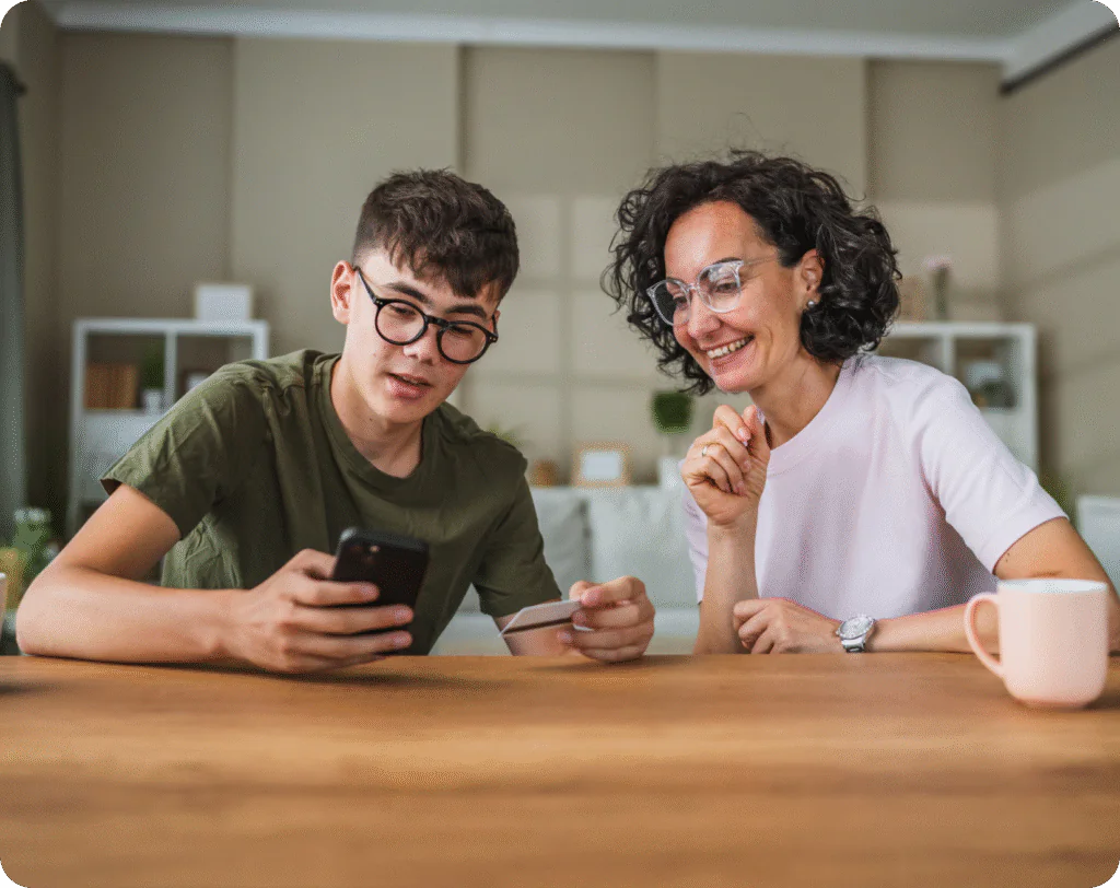 mother and son looking at mobile banking app